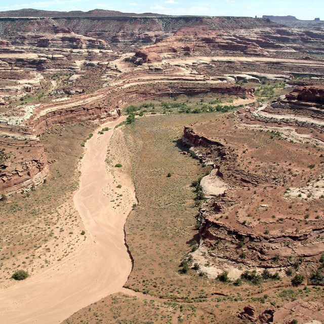 Incredible desert vista with wash snaking through colorful layers of rock