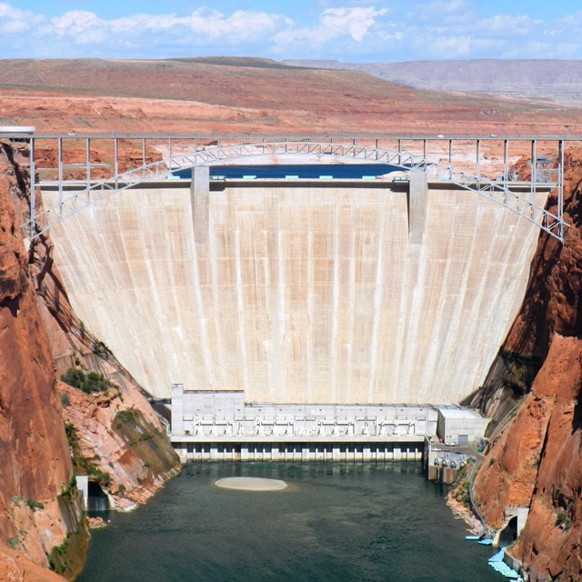 Concrete gravity arch dam in a sandstone canyon