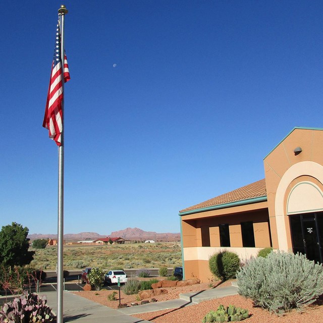 Office building with an American flag flying in front