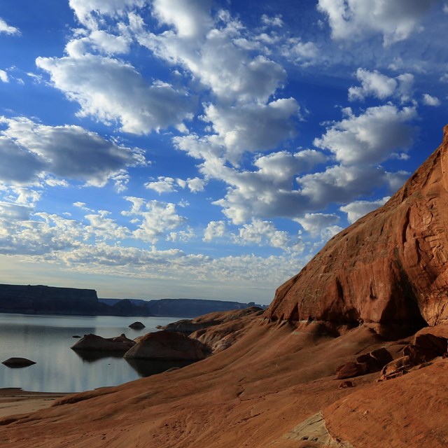 Landscape scene with sandstone wall and lake