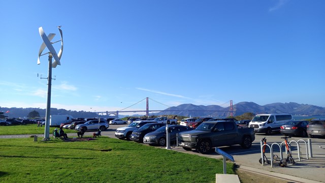 Electric vehicles charge at a new charger donated by Rivian at the East Crissy Field parking lot. 