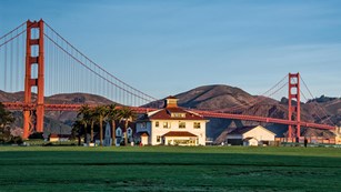 white building with gg bridge in the beckground