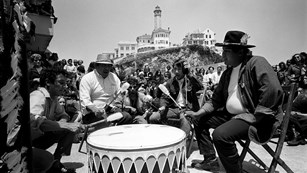people gather around a drum circle on alcatraz 1969