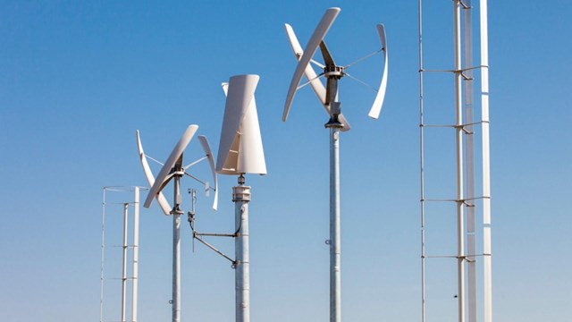 three wind turbines against a blue sky