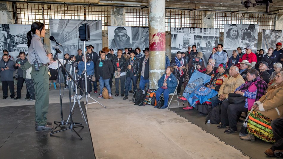 Red painting of Red Power and face with horns, on tan wall