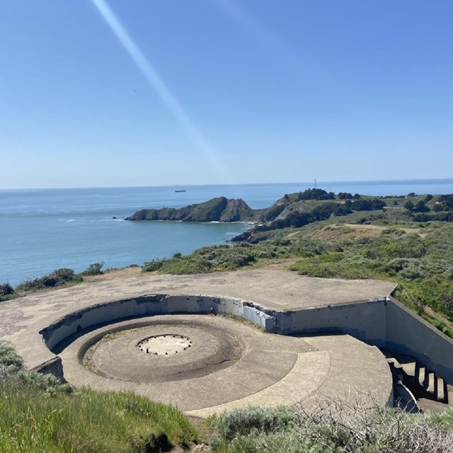 View of concrete casemate with Point Bonita in the distance.