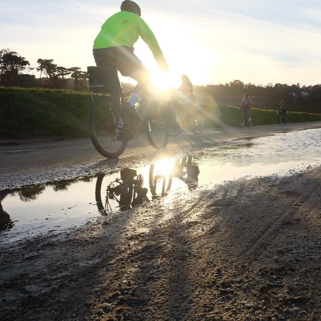 cyclist by a puddle
