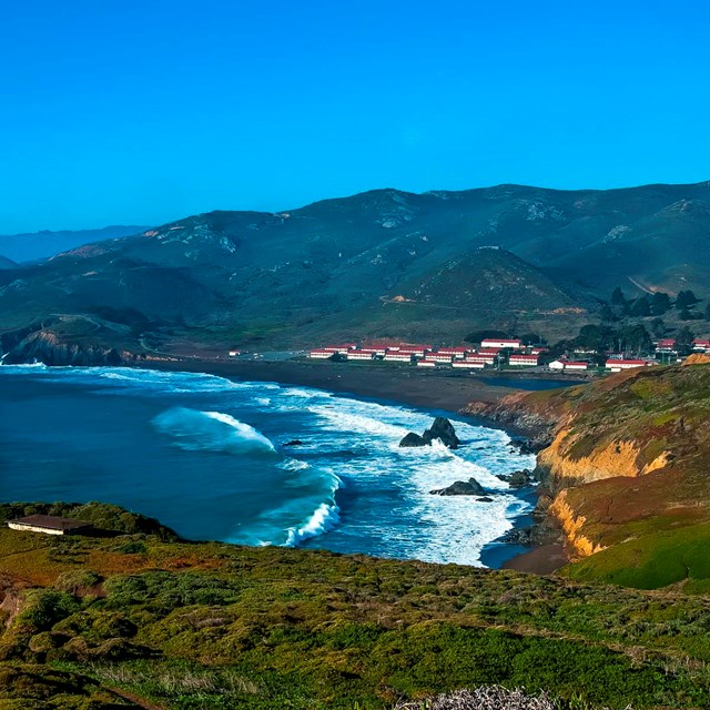 View of the waves at Rodeo Beach and the barracks of Fort Cronkhite