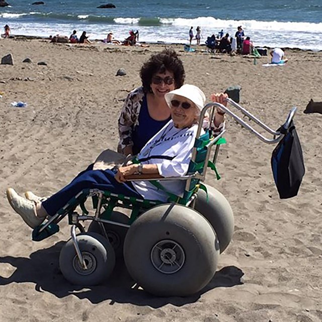 Women sitting in a beach wheelchair. 