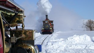 The No. 119 billows steam and smoke at the last spike site.