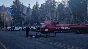 Search and rescue team with red helicopter.