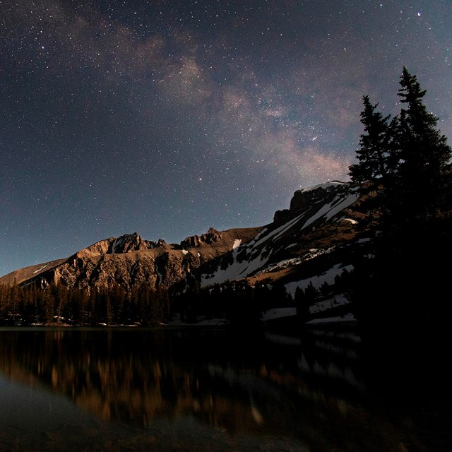 Mountain Lake and Wheeler peak illuminated at night by the moon.