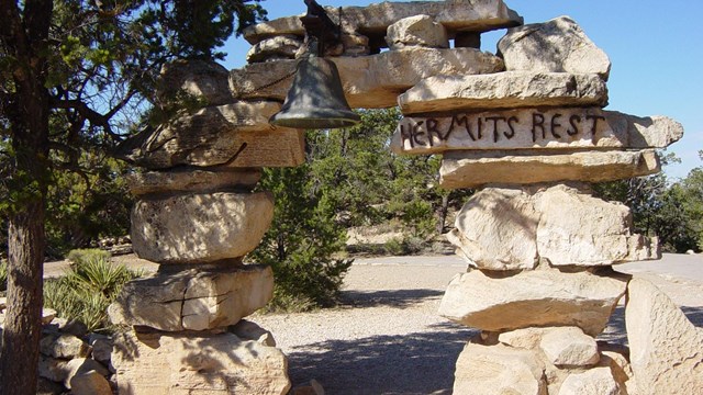 An stone arch structure with a bell on the top.