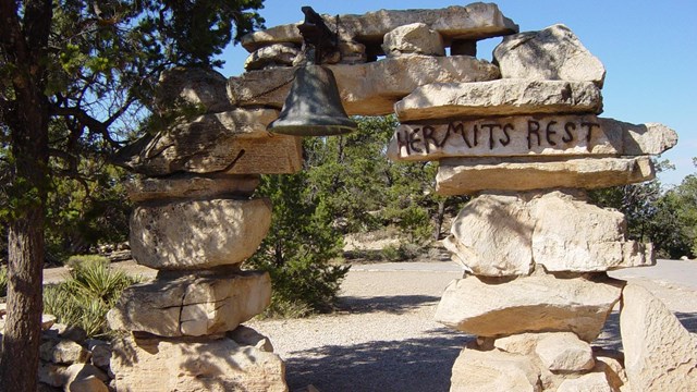 A stone arch with a bell on the top