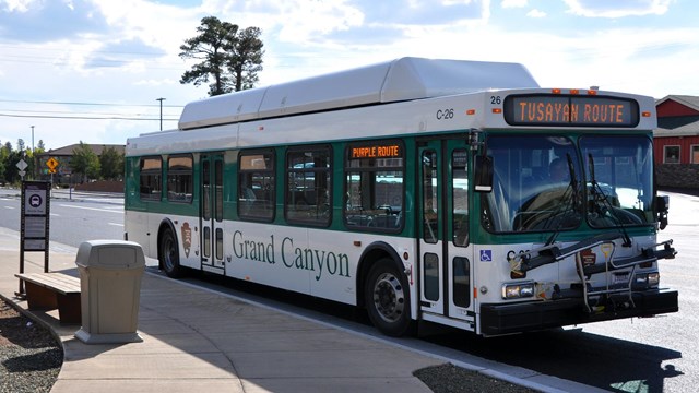 A Tusayan Shuttle bus completes a stop in Tusayan on a return trip to Grand Canyon National Park.