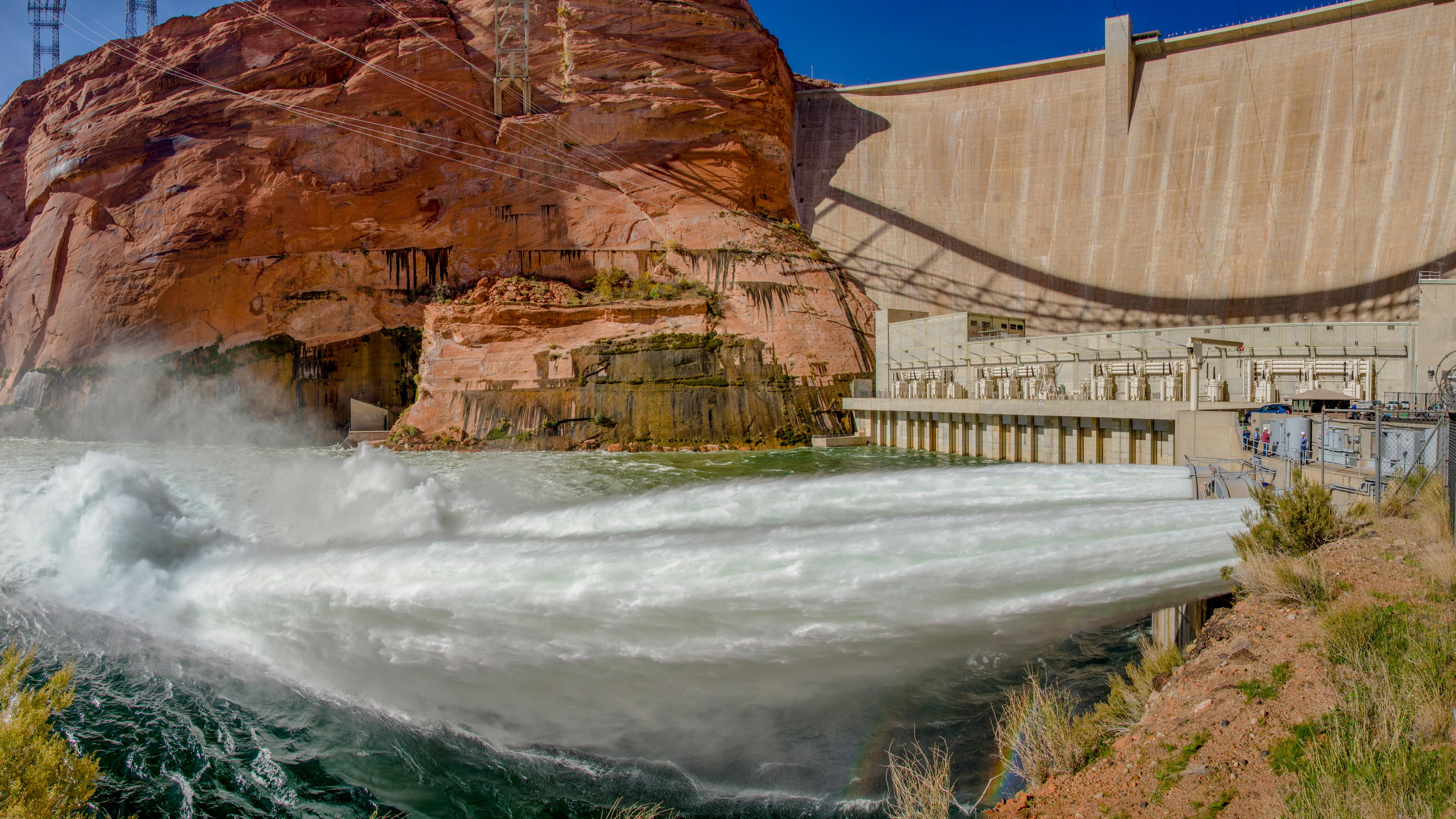 In the foreground, jets of water being released from the base of Glen Canyon Dam. 