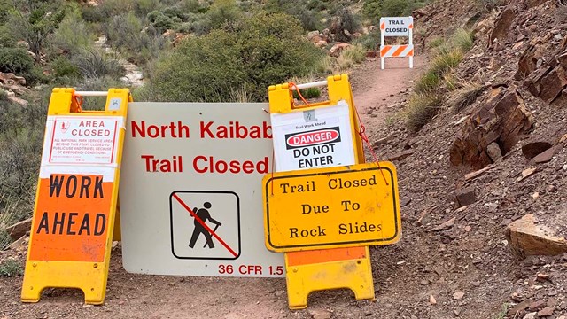 Closure sign reads, 'WORK AHEAD'. North Kaibab Trail Closed Due To Rock Slides. Danger, do not enter