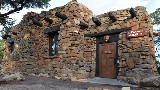 A small single-story stone building with an entry on the right. Sign reads: Tusayan Museum. 