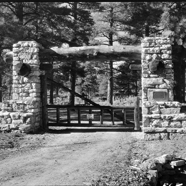 A black and white photo of the gate of the Pioneer Cemetery.