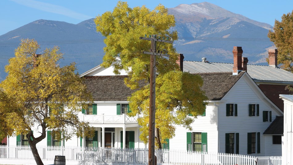 Front of ranch house with snow on the ground and a sleigh in front