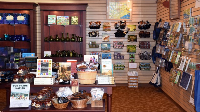 Interior view of tables and display racks with merchandise.