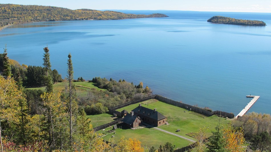 Blue water of Lake Superior contrasts with green forests.