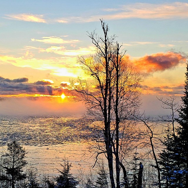 Sunrise over a foggy bay.