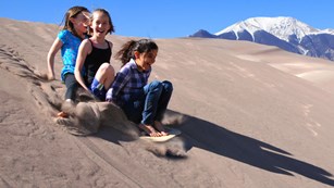 Girls Sand Sledding