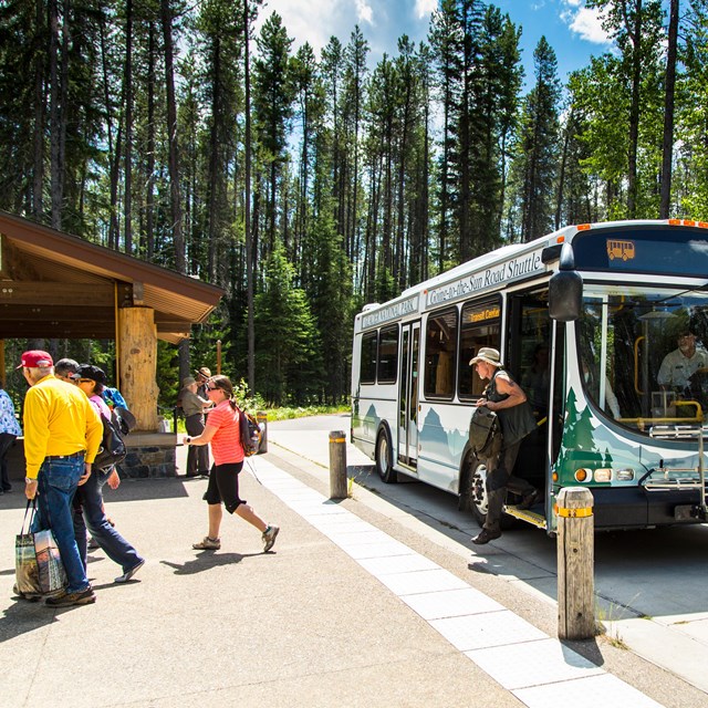 A person disembarks a bus that reads 