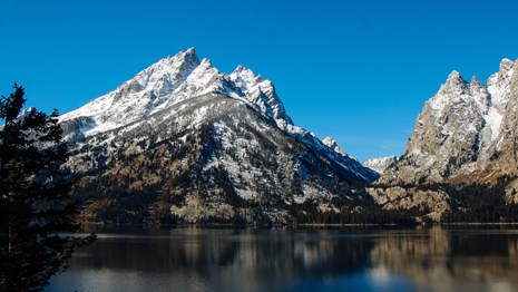Mountains across a calm lake.