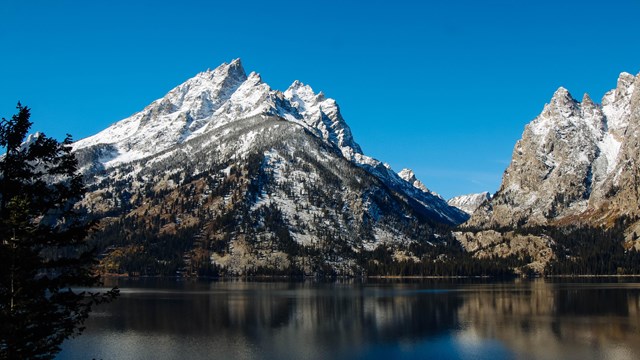 Mountains across a calm lake.