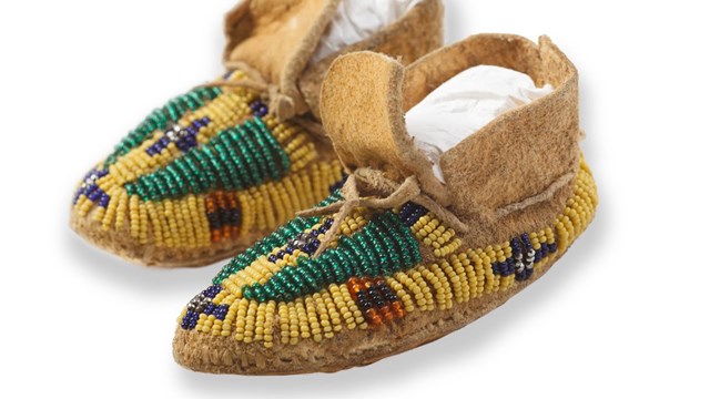 Beaded leather moccasins with green, yellow, and purple beads