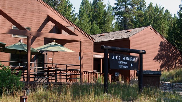 Front of Leeks Pizzeria with brown wood siding.