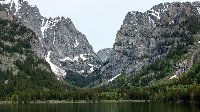 A mountain canyon across a lake.