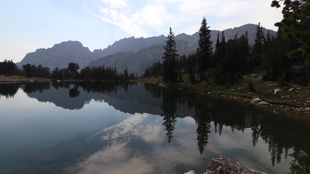 An alpine lake situated beneath rocky mountain peaks