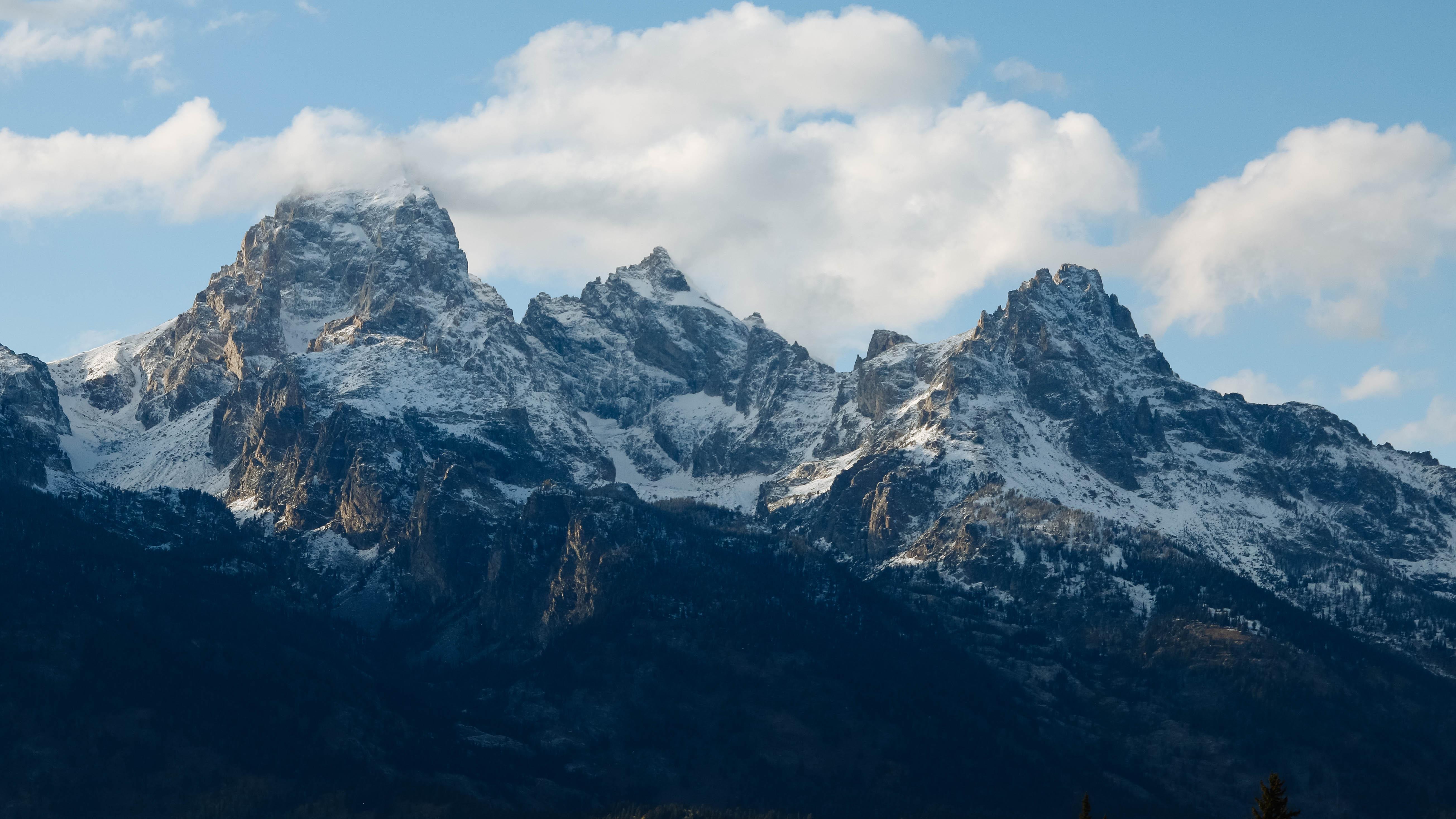 Mountains rise against a partly cloudy sky.