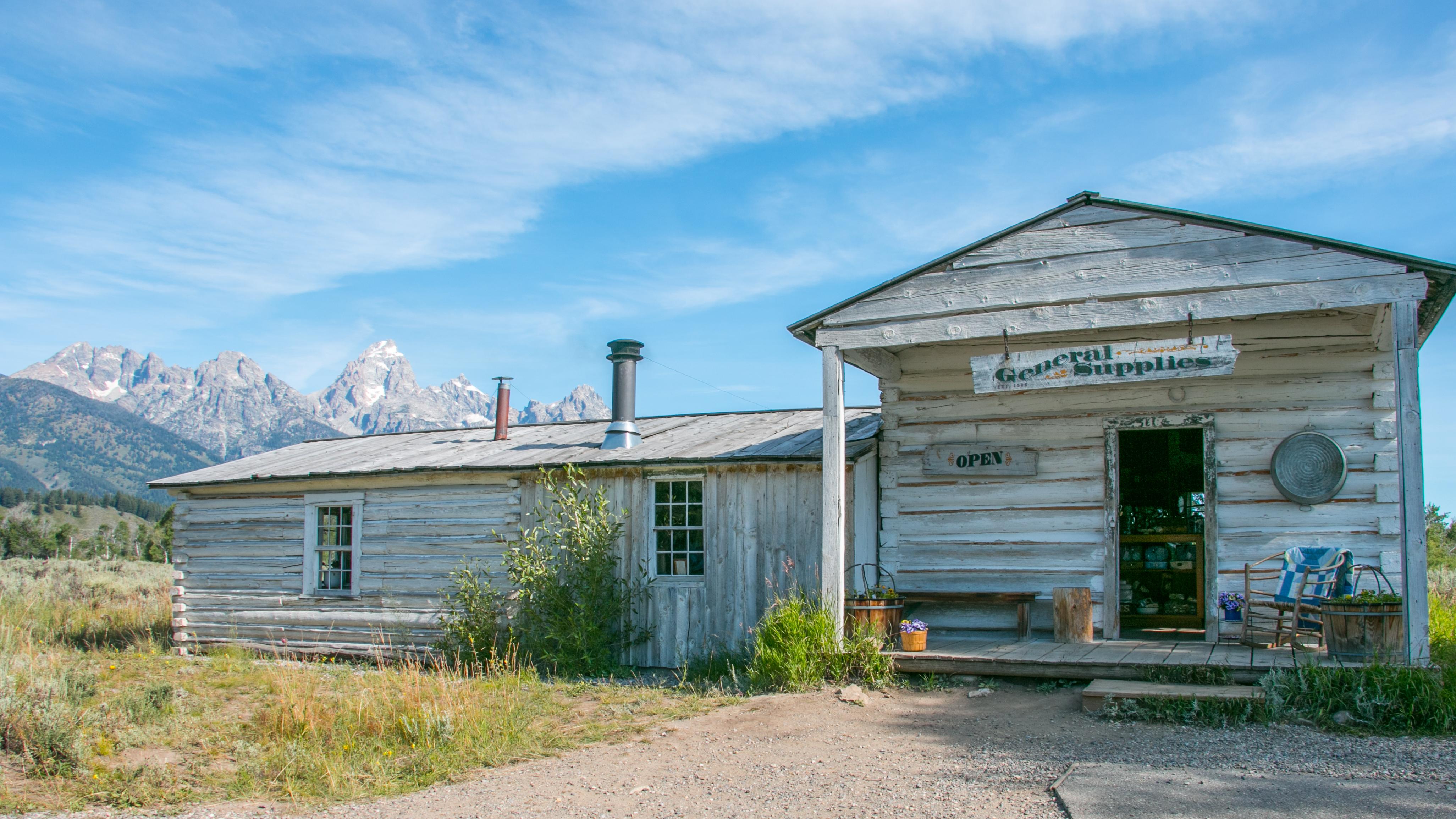 A white building with mountains in the background.