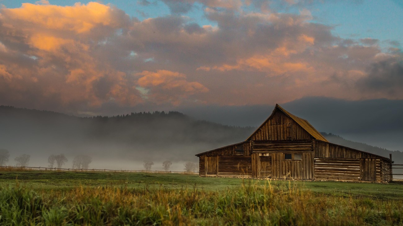A barn surrounded by mist.