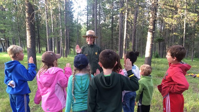 Kids being sworn in as junior rangers by a park ranger