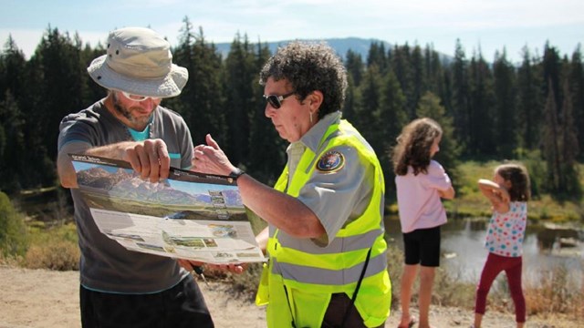 A volunteer gives directions to a visitor in Grand Teton National Park