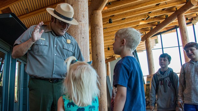 Kids take the junior ranger pledge with a park ranger