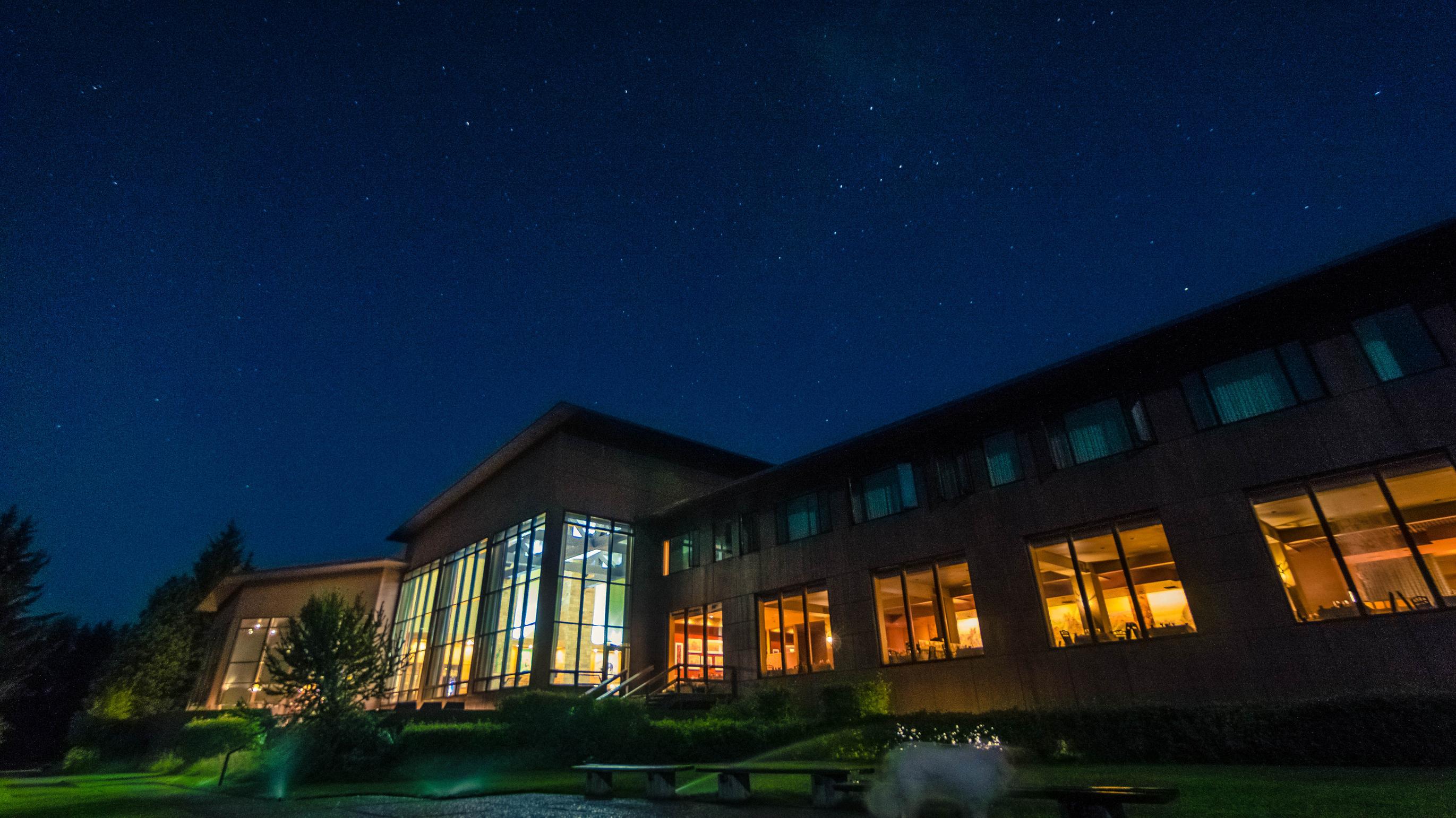 Jackson Lake Lodge at night highlighting the wall of windows.