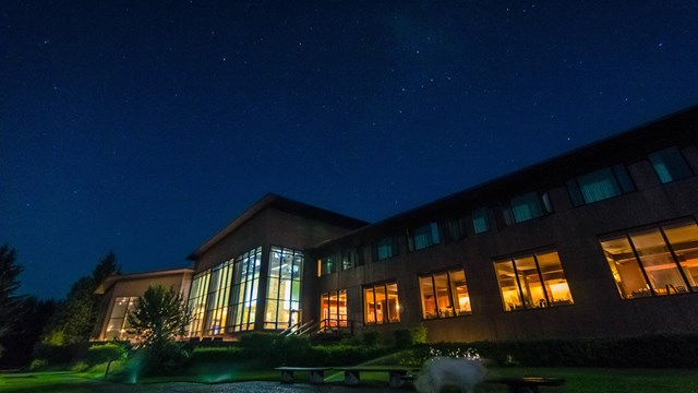 Jackson Lake Lodge at night highlighting the wall of windows.