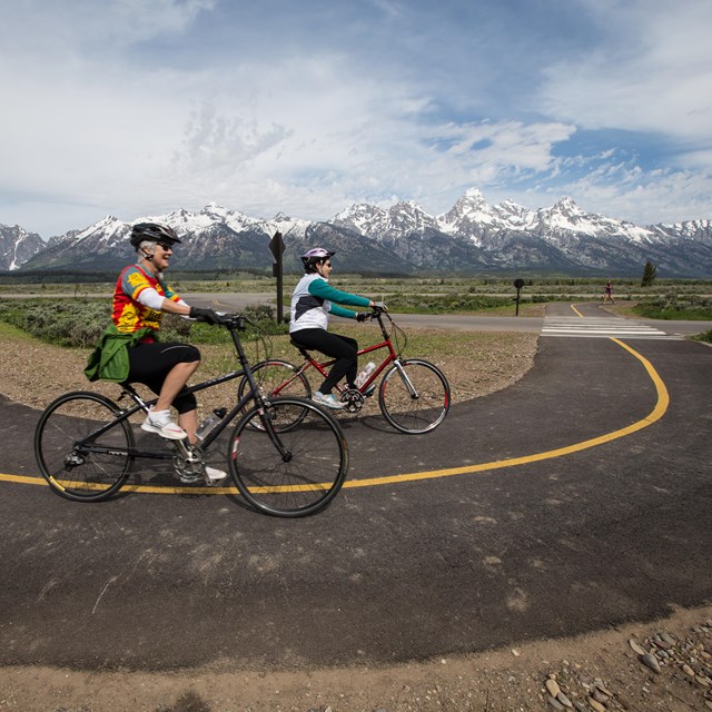 Bikers biking along the multi-use pathway