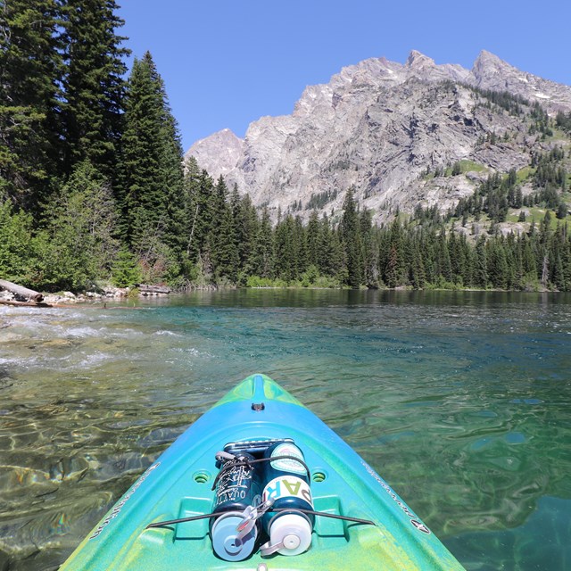 A lake and mountain as seen from the perspective of a kayaker