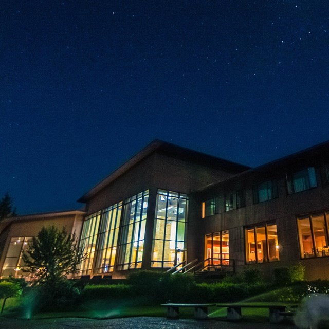 Jackson Lake Lodge at night highlighting the wall of windows.