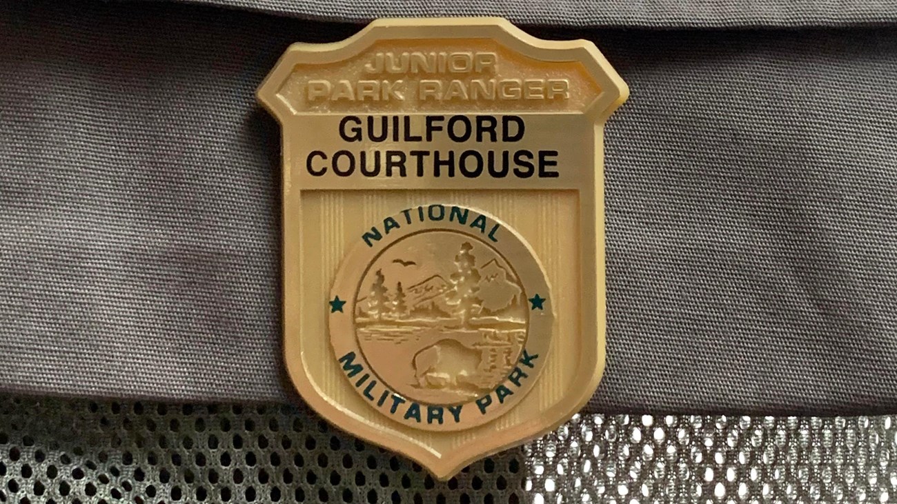 A "Junior Ranger" vest with a junior ranger badge for Guilford Courthouse National Military Park