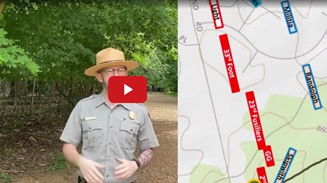 Park Ranger talking next to a battle map