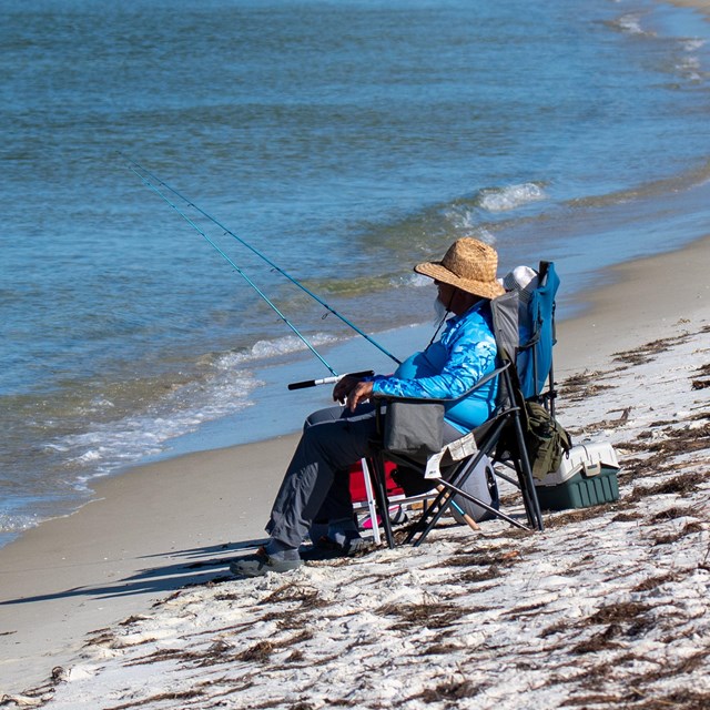 A fisherman casts a line.