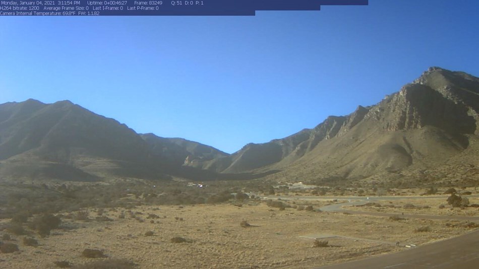 Screenshot of a webcam image showing a wide canyon in desert mountains